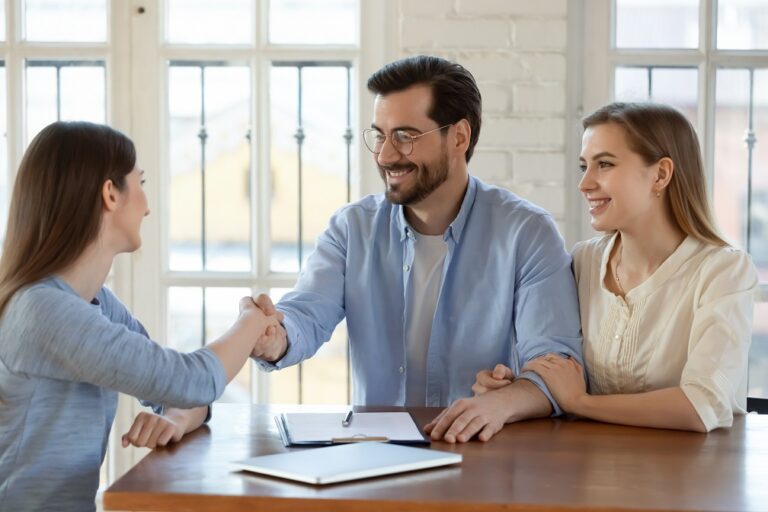 Happy,Young,Married,Family,Couple,Shaking,Hands,With,Real,Estate