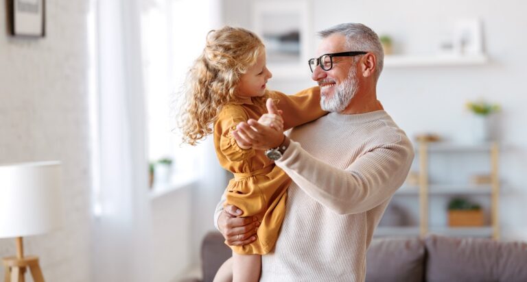 Elegant,Loving,Caring,Grandfather,Looking,At,His,Cute,Little,Granddaughter,