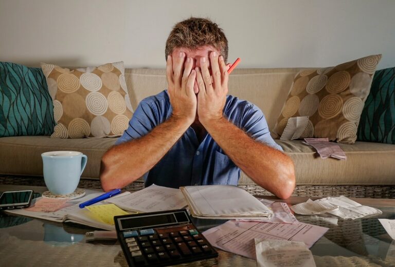 Worried,And,Stressed,Man,At,Home,Calculating,Month,Tax,Expenses