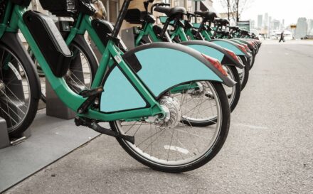 E-bikes sitting in a park station on a city street