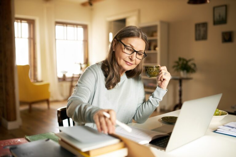 Serious,Confident,Middle,Aged,Female,Journalist,With,Cup,Of,Coffee