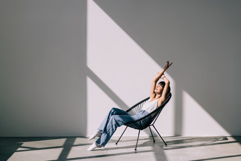 Young,Woman,At,Home,Sitting,On,Modern,Chair,Relaxing,In