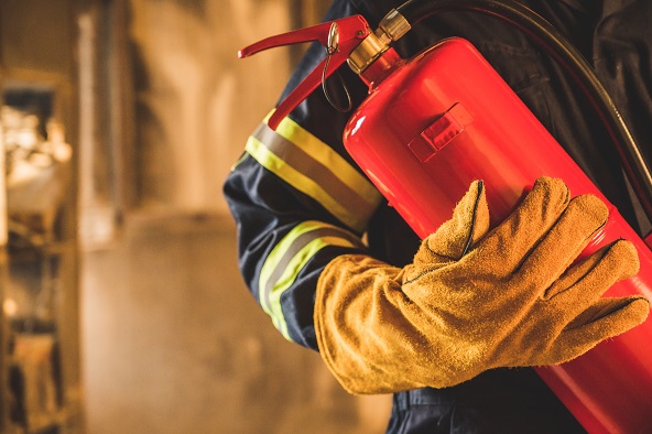 Close,Up,Hand,Fireman,firefighter,Holding,The,Fire,Extinguisher.