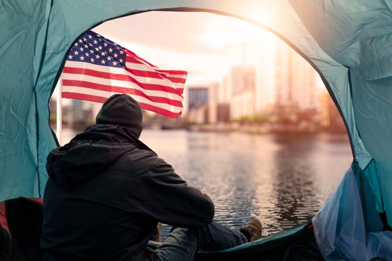 Homeless,Man,In,A,Tent,In,Focus.,City,And,Usa