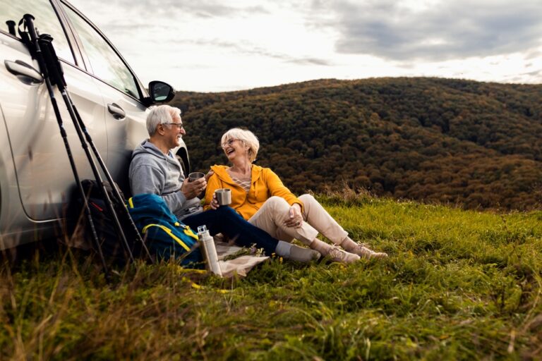 Senior,Couple,Sitting,Against,The,Car,,Resting,After,Hiking,In