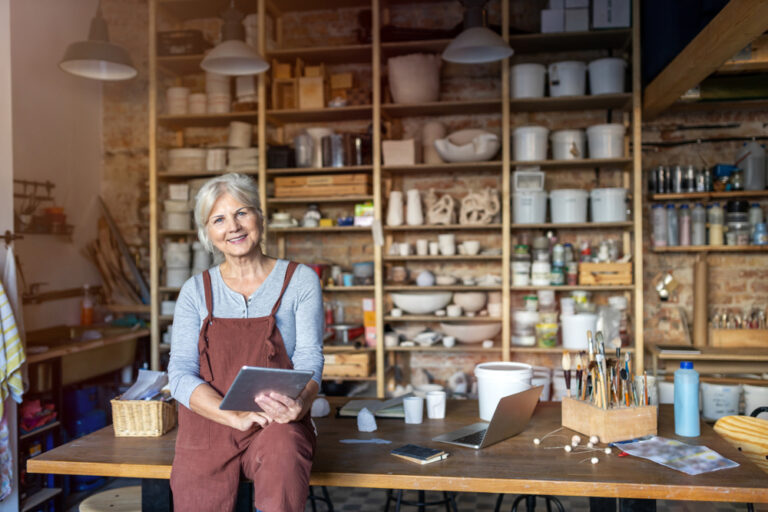 Senior,Craftswoman,With,Tablet,Computer,In,Art,Studio