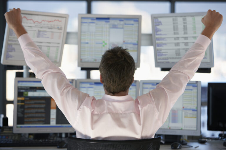 Rear,View,Of,Stock,Trader,With,Hands,Raised,Looking,At