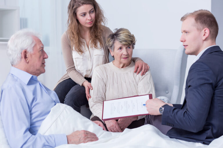 Shot,Of,A,Family,Listening,To,A,Young,Man,Holding