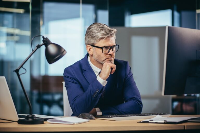 A,Gray-haired,Man,With,Glasses,Thinks,About,The,Tasks,,A