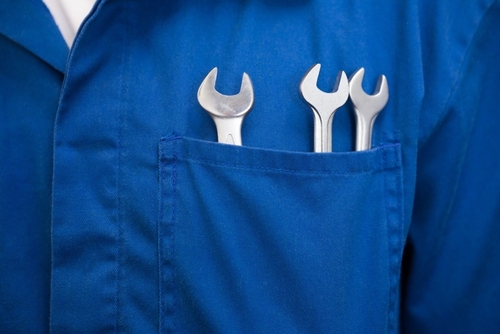 Mechanic with wrenches in pocket