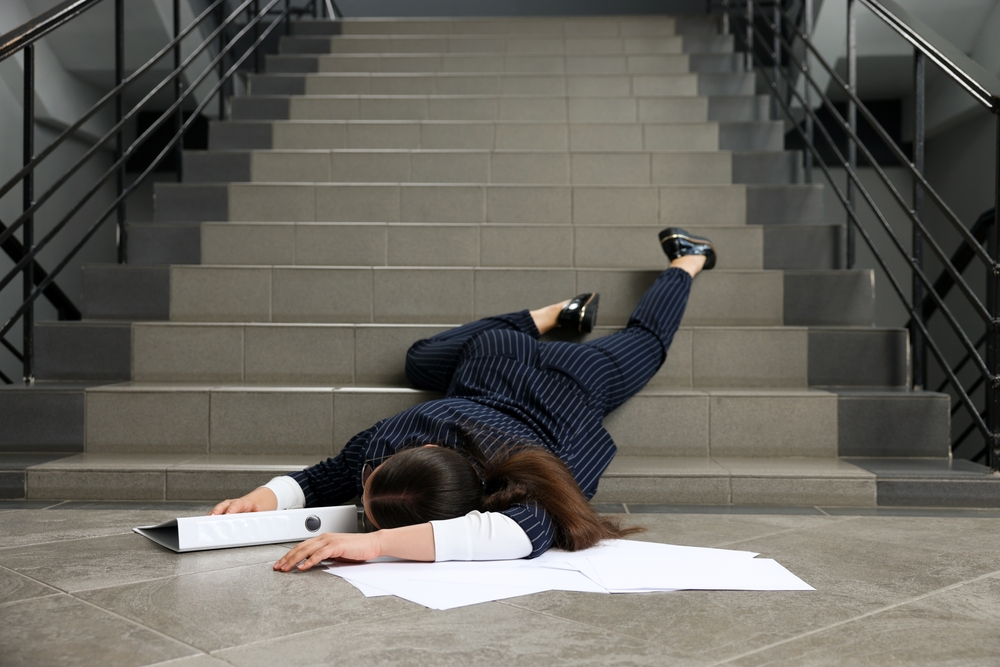 Unconscious,Woman,With,Scattered,Folder,And,Papers,Lying,On,Floor