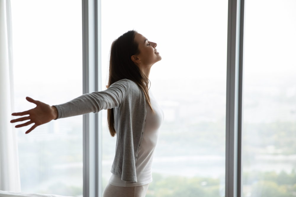 Happy,Young,Woman,Stand,Near,Window,Breathe,Fresh,Air,Stretch