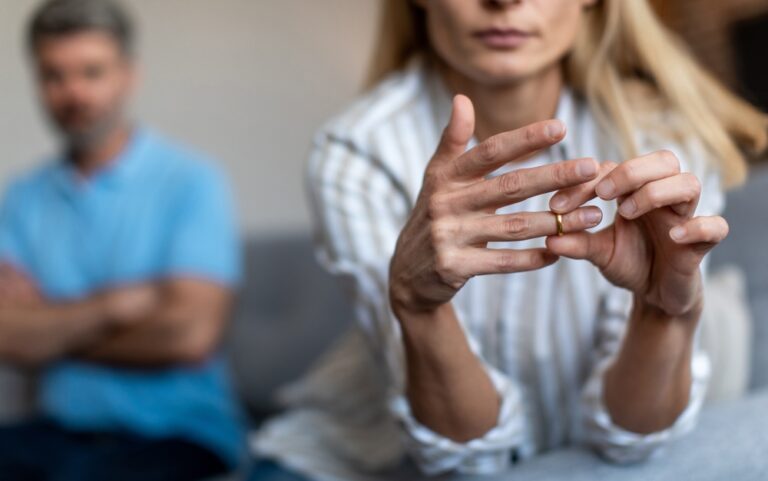 Unhappy,Middle,Aged,European,Lady,Takes,Off,Ring,,Ignoring,Man