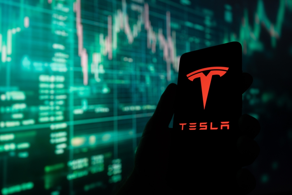 Tesla,Motors,Logo,On,Smartphone,Screen,,Green,Stock,Market,Chart