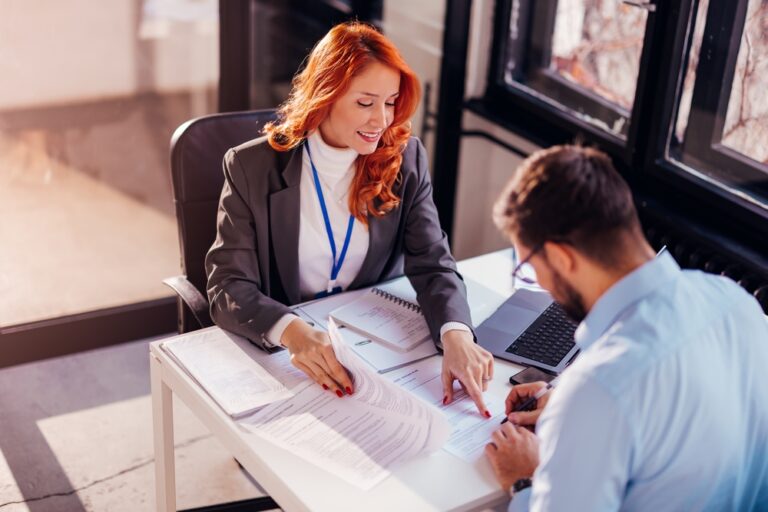 Business,People,Man,And,Woman,Sitting,At,The,Table,In