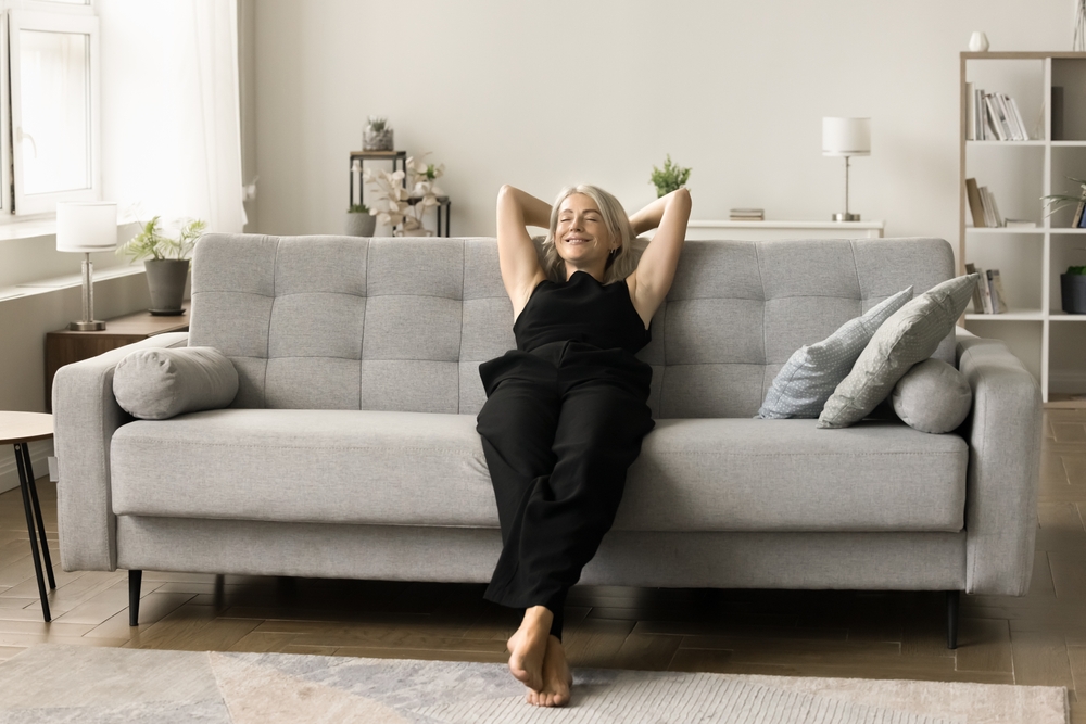 Peaceful,Happy,Senior,Lady,Resting,On,Couch,With,Closed,Eyes,