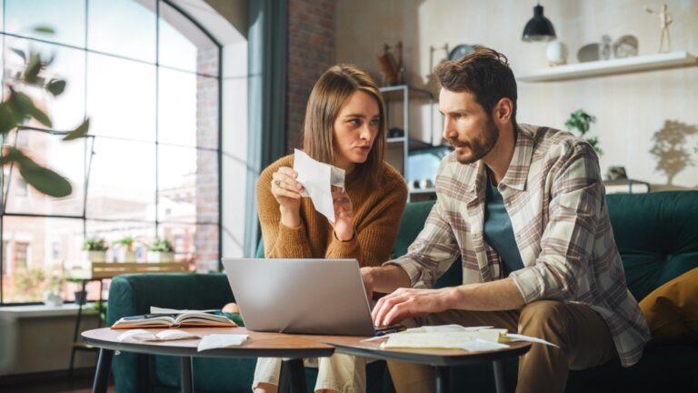 Accounting,At,Home:,Couple,Using,Laptop,Computer,,Consulting,Eachother,In